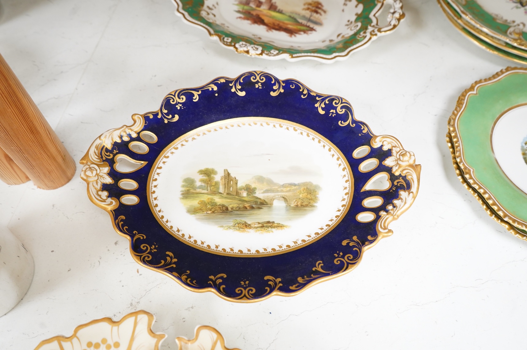 A collection of 19th century English dessert wares to include a pair of Flight, Barr and Barr ‘fantastic birds’ green ground dessert plates, various Ridgway dessert plates, five Minton botanical plates with tooled gilt b